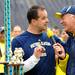 Former Michigan quarterback John Wangler, left, speaks with Michigan football commentator Frank Beckmann during Saturday's alumni flag football game. Melanie Maxwell I AnnArbor.com
